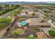 Lovely aerial view of this home showcasing the backyard with a pool, patio, and lush landscaping at 14539 W Becker Ln, Surprise, AZ 85379