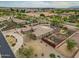 Aerial view showcases a large property with a sparkling pool, extensive landscaping, and circular driveway at 14539 W Becker Ln, Surprise, AZ 85379