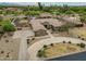 Aerial view of a home with a circular driveway, impeccable landscaping, and a grand front entrance at 14539 W Becker Ln, Surprise, AZ 85379
