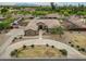 Stunning aerial view of a home with a circular driveway, beautiful landscaping, and a welcoming entrance at 14539 W Becker Ln, Surprise, AZ 85379