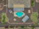 Aerial view of the backyard featuring a pool, spa, patio, and lush desert landscaping at 14539 W Becker Ln, Surprise, AZ 85379