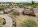 Aerial view of a home with circular driveway, manicured grounds, lovely landscaping and a long driveway at 14539 W Becker Ln, Surprise, AZ 85379