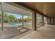 A covered back patio shows the refreshing pool, relaxing hot tub, and beautiful desert landscaping in backyard at 14539 W Becker Ln, Surprise, AZ 85379