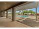 Covered patio offering stunning views of the pool and the beautifully landscaped backyard at 14539 W Becker Ln, Surprise, AZ 85379