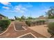 A manicured backyard has mature landscaping and brick-lined walkways at 14539 W Becker Ln, Surprise, AZ 85379