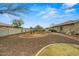 A low-maintenance backyard features mature desert landscaping and neutral colored exterior at 14539 W Becker Ln, Surprise, AZ 85379