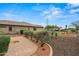 A gorgeous low-maintenance backyard has mature landscaping and a brick walkway at 14539 W Becker Ln, Surprise, AZ 85379