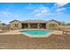 Beautiful private pool with an artistic design, surrounded by a patio and desert landscaping at 14539 W Becker Ln, Surprise, AZ 85379