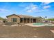 An outdoor oasis has a pool, hot tub, covered patio, and plenty of desert landscaping at 14539 W Becker Ln, Surprise, AZ 85379