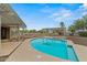 The lovely backyard features a sparkling swimming pool and manicured desert landscaping at 14539 W Becker Ln, Surprise, AZ 85379