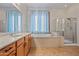 Bathroom featuring a glass shower, soaking tub, and a vanity at 14539 W Becker Ln, Surprise, AZ 85379