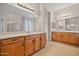 Dual sink bathroom vanity with mirror, and tile flooring, including a shower at 14539 W Becker Ln, Surprise, AZ 85379