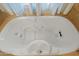 Top-down view of soaking tub featuring jets and cushioned headrest at 14539 W Becker Ln, Surprise, AZ 85379