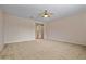 Neutral-toned bedroom with plush carpeting leading to another room at 14539 W Becker Ln, Surprise, AZ 85379