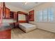 Bedroom featuring built in cabinets, desk, murphy bed, and plantation shutters at 14539 W Becker Ln, Surprise, AZ 85379