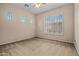 Neutral bedroom featuring carpet, a ceiling fan, and multiple windows including one with plantation shutters at 14539 W Becker Ln, Surprise, AZ 85379
