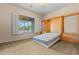 Cozy bedroom showcasing a unique built-in Murphy bed and a window with plantation shutters offering natural light and outdoor views at 14539 W Becker Ln, Surprise, AZ 85379