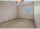 Inviting bedroom with plush carpeting, a ceiling fan, and natural light from the window with plantation shutters at 14539 W Becker Ln, Surprise, AZ 85379