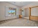 Spacious bedroom featuring neutral tones, plush carpeting, and a window with plantation shutters with a lovely outdoor view at 14539 W Becker Ln, Surprise, AZ 85379