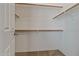 Walk-in closet with wooden rails and shelving at 14539 W Becker Ln, Surprise, AZ 85379