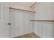 Walk-in closet with wooden rails and shelving at 14539 W Becker Ln, Surprise, AZ 85379