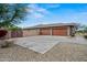 Wide driveway leading to a spacious three-car garage, desert landscaping, and a secure gated entrance at 14539 W Becker Ln, Surprise, AZ 85379