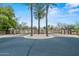 Gated community entrance featuring lush landscaping, a decorative median, and secure access at 14539 W Becker Ln, Surprise, AZ 85379