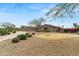 Charming single-story home featuring desert landscaping, a circular driveway, and a neutral color palette at 14539 W Becker Ln, Surprise, AZ 85379