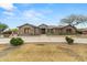 Charming home featuring a well-manicured front yard, a long private driveway, and desert landscaping at 14539 W Becker Ln, Surprise, AZ 85379