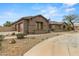 Attractive desert home with a circular driveway, rock landscaping, and large attached garage at 14539 W Becker Ln, Surprise, AZ 85379