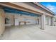 Spacious garage with plenty of storage, built in cabinets, shelving and work space at 14539 W Becker Ln, Surprise, AZ 85379