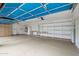 Well-organized three-car garage featuring shelving and storage cabinets to maximize space at 14539 W Becker Ln, Surprise, AZ 85379