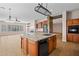 Spacious kitchen with large island, dishwasher and open to the living area and fireplace at 14539 W Becker Ln, Surprise, AZ 85379