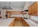 An open kitchen offers wood cabinets, stainless steel appliances, and granite countertops at 14539 W Becker Ln, Surprise, AZ 85379