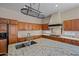 Bright kitchen with a large center island, wooden cabinets, and granite countertops at 14539 W Becker Ln, Surprise, AZ 85379