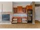 Living room built-ins with a wine cooler, fireplace, and storage with pull out drawers at 14539 W Becker Ln, Surprise, AZ 85379