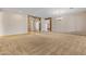 Spacious living area featuring neutral walls, carpet flooring, and open access to other areas of the home at 14539 W Becker Ln, Surprise, AZ 85379