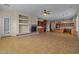 Bright living room with fireplace and built-in shelving, open to the kitchen and breakfast area at 14539 W Becker Ln, Surprise, AZ 85379