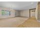Open living space with neutral carpet, views to the outside, and open layout at 14539 W Becker Ln, Surprise, AZ 85379