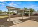 Serene outdoor pergola area featuring a dining area and space for entertaining guests at 14539 W Becker Ln, Surprise, AZ 85379