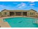 Inviting backyard pool with a dolphin mosaic, covered patio, and comfortable seating area at 14539 W Becker Ln, Surprise, AZ 85379