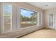 Bright room with plantation shutters offering a view of the backyard pool and patio at 14539 W Becker Ln, Surprise, AZ 85379