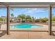 The refreshing swimming pool has a pergola and mature desert landscaping at 14539 W Becker Ln, Surprise, AZ 85379