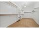 Large walk-in closet with carpet, shelving, and hanging rods at 14539 W Becker Ln, Surprise, AZ 85379