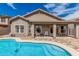 Backyard featuring a pool, patio, and low-maintenance desert landscaping at 15829 W Boca Raton Rd, Surprise, AZ 85379