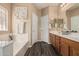 Bathroom showcasing a double sink vanity, white bathtub, and stylish decor at 15829 W Boca Raton Rd, Surprise, AZ 85379