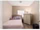 Cozy bedroom with a bed, storage cabinet, and ample natural light at 15829 W Boca Raton Rd, Surprise, AZ 85379