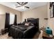 Stylish bedroom features a black bed and modern decor at 15829 W Boca Raton Rd, Surprise, AZ 85379