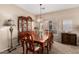 Formal dining room with classic wood table and china cabinet at 15829 W Boca Raton Rd, Surprise, AZ 85379