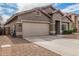 Charming single-story home featuring a two-car garage and a well-maintained front yard at 15829 W Boca Raton Rd, Surprise, AZ 85379